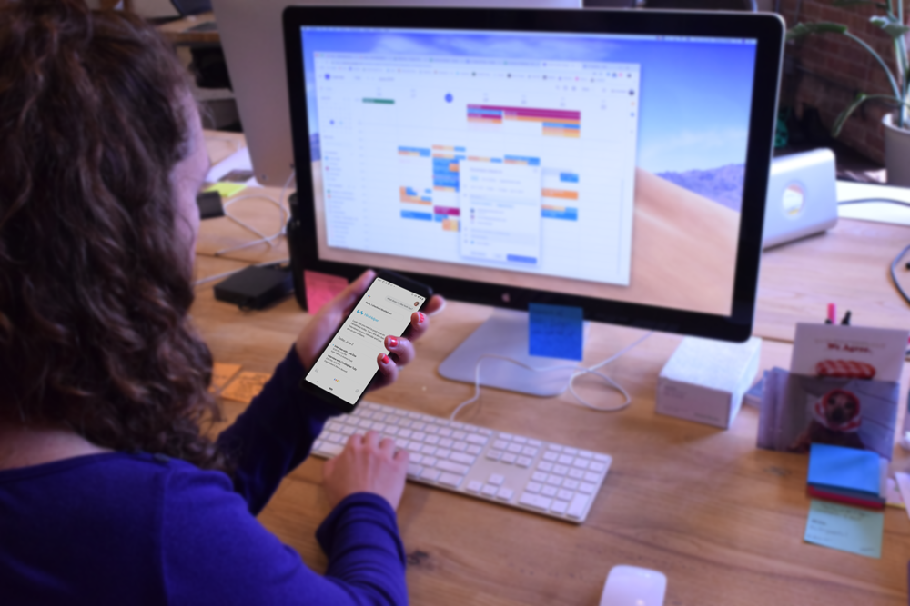A Grand Studio designer testing a prototype between desktop and mobile