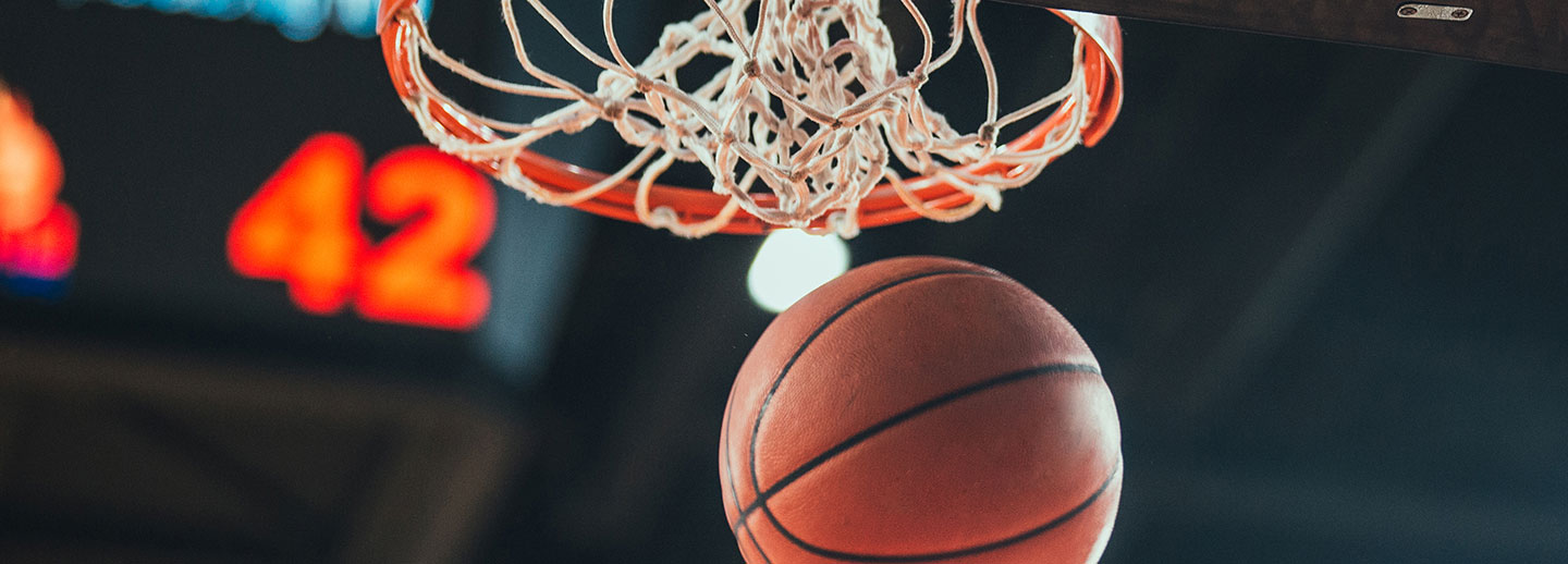 A basketball gliding through the net.