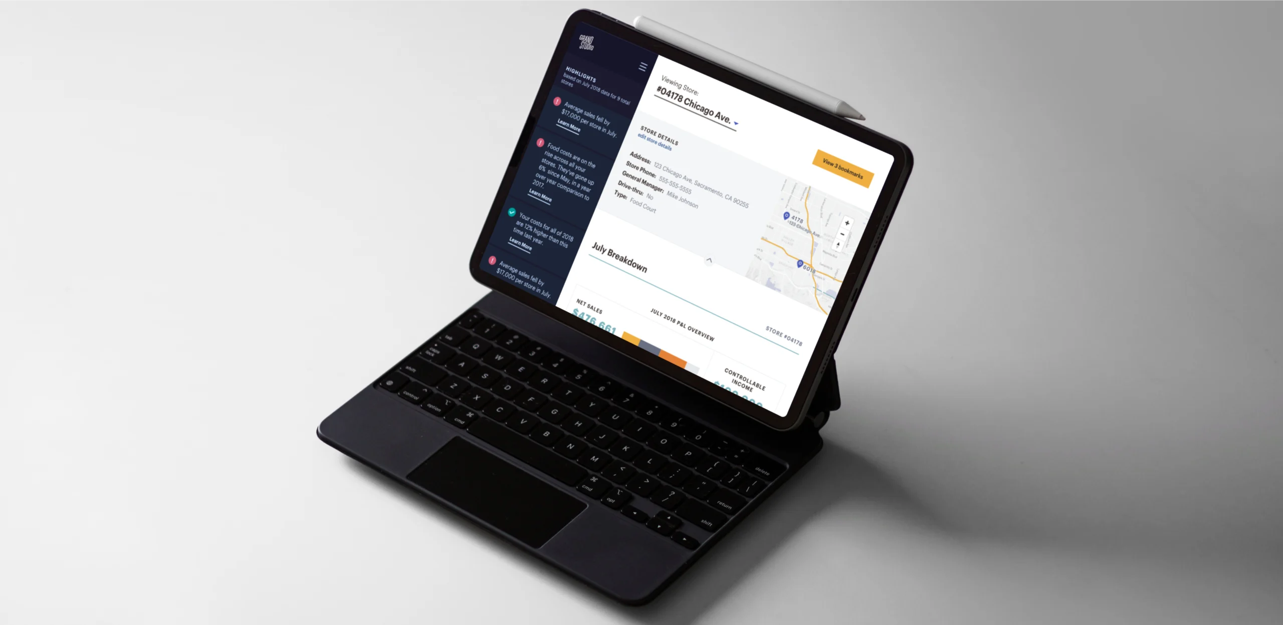 Franchise AI dashboard on a tablet with keyboard showing store details and July performance breakdown.