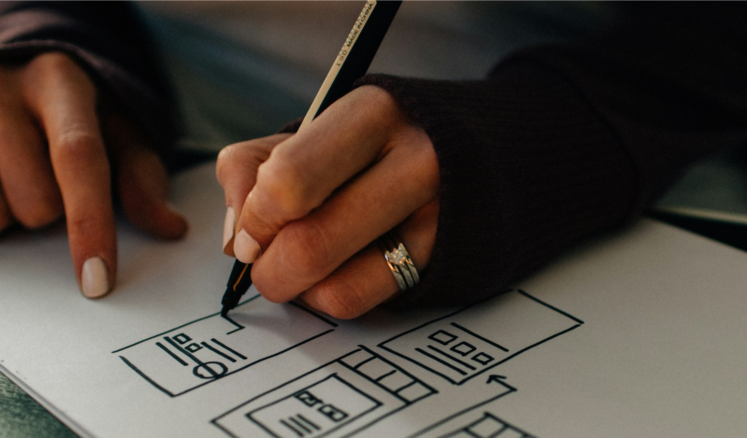 Hand sketching wireframes of a franchise AI dashboard interface.